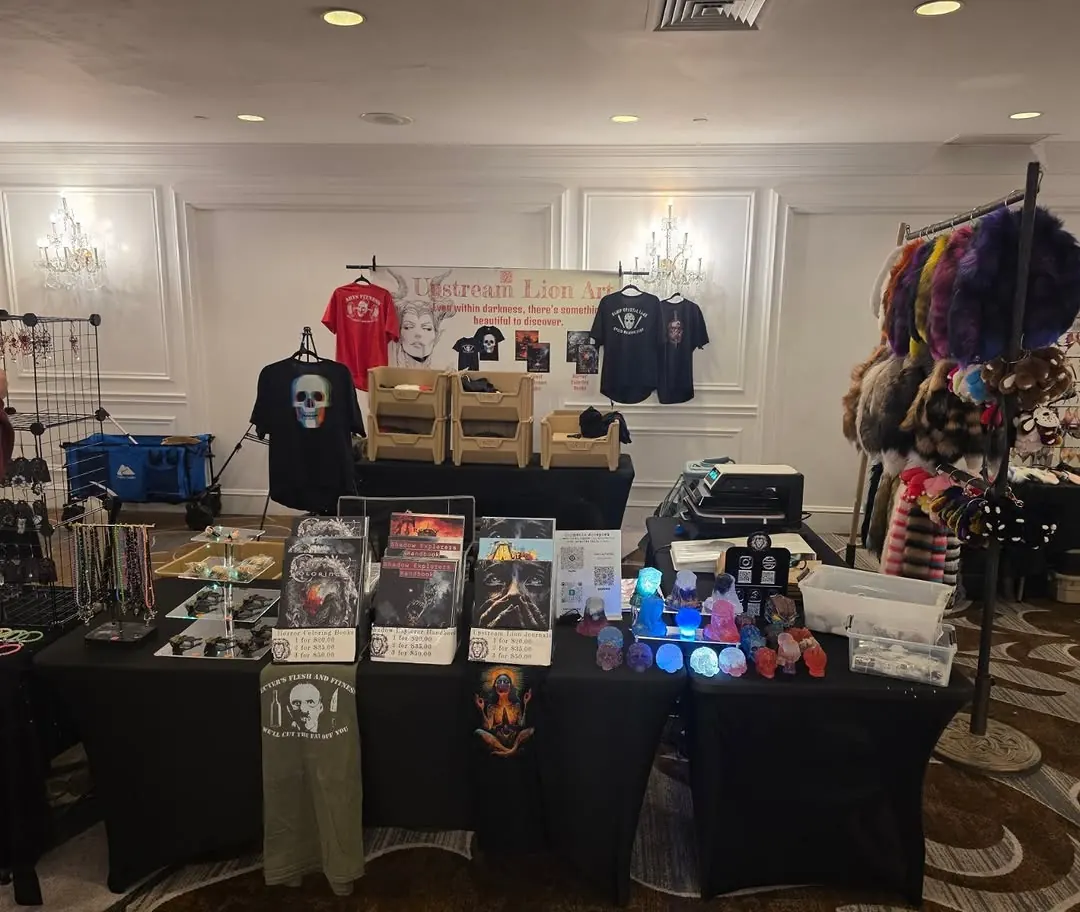 Ballroom vendor table with books, skulls and t-shirts on display