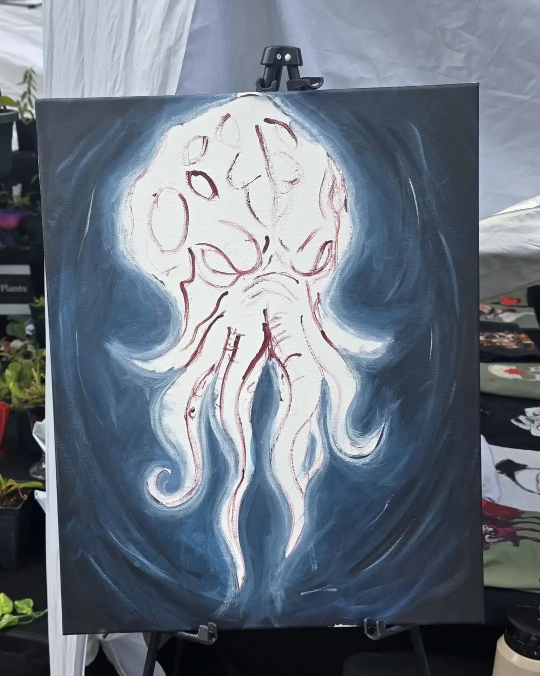 Cthulhu painting half finished, white head on a dark blue ground