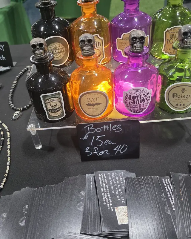 Row of glowing apothecary bottles topped with resin skulls