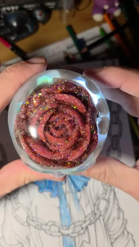 Clear resin sphere with a red glitter rose inside