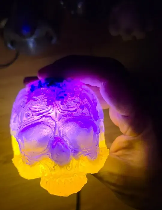 Resin skull lamp glowing purple fading to yellow